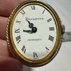 Gold Roman Numeral clock face not sure if it’s a piece of watch or decor